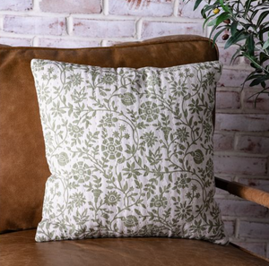 18-inch green floral decorative pillow with botanical pattern on a sofa
