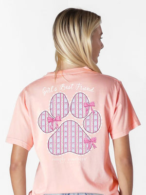 Person wearing a pink t-shirt with a paw print design and text on the back.