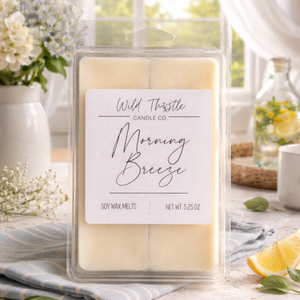 Packaged soy wax melt with 'Morning Breeze' scent on a decorative surface with flowers and lemon slices.