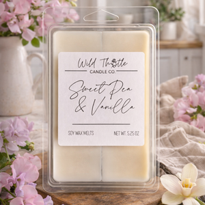 Pack of Wild Thistle Candle Co. sweet pea and vanilla soy wax melts with flowers in the background